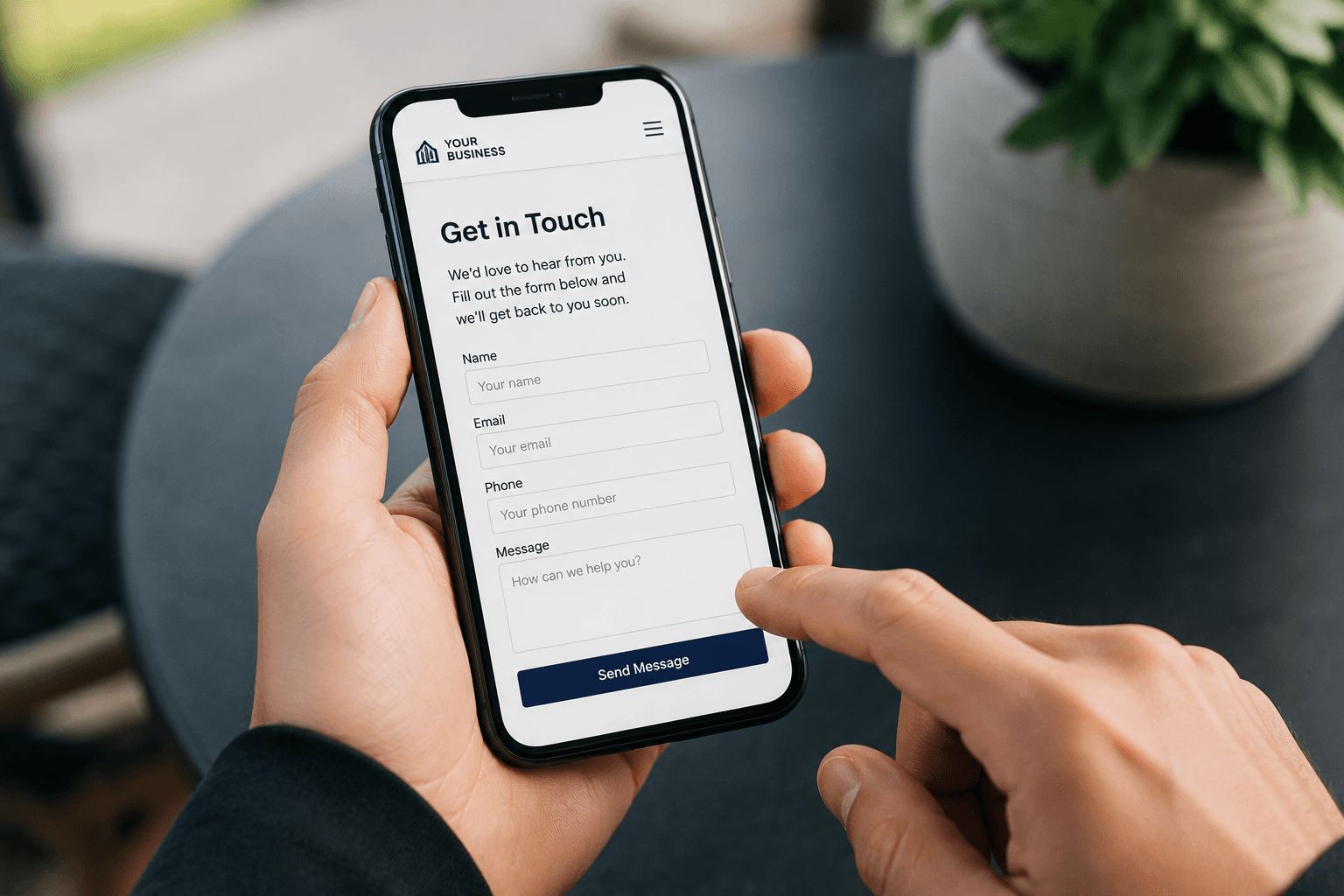 Hands holding a smartphone displaying a "Get in Touch" contact form with various input fields.
