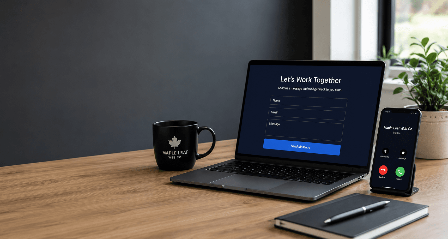 Laptop with contact form, smartphone with incoming call, black mug, and notebook on wooden desk.